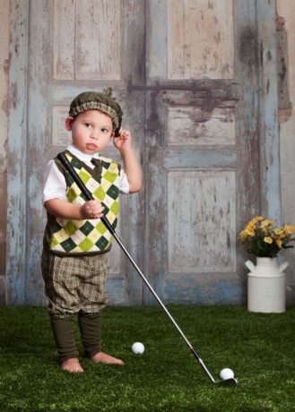 Junior golf - kid dressed in old fashioned gear